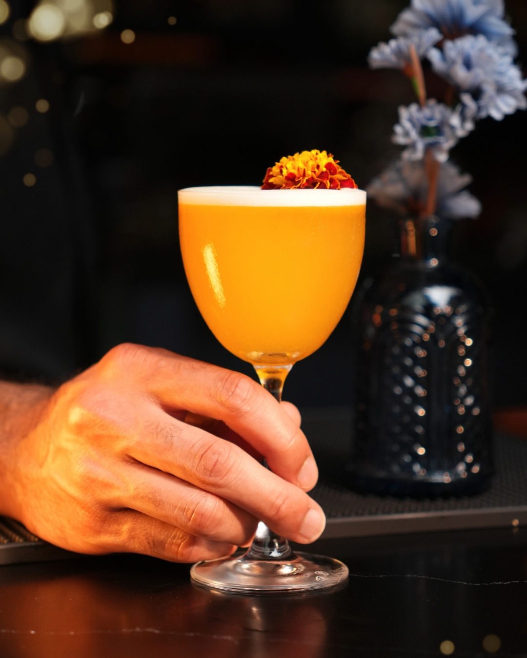 Golden, silky, and topped with a tiny flower 🍹
