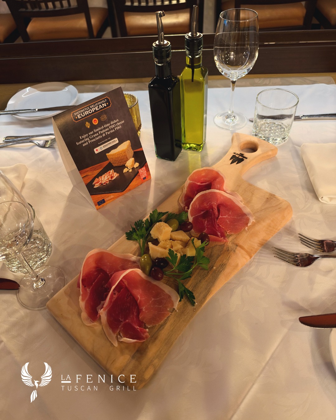 Introducing a refined appetizer featuring Prosciutto di Parma PDO, Grana Padano PDO, and Mediterranean olives, delicatel